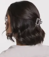 Set de dos pinzas para el pelo plateadas con incrustaciones de strass, una con forma de media luna y otra rectangular.