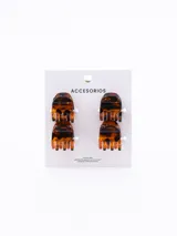 Set de cuatro pinzas pequeñas de plástico negro para el pelo.