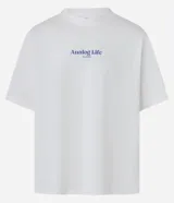 Remera de algodón blanca, corte oversized, con estampa gráfica en la espalda que incluye un teléfono antiguo, un CD, una cámara fotográfica, auriculares y un reproductor de CD portátil, junto al texto "Analog Life - NO EDITS -".