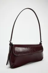 Bolso de hombro color borgoña con efecto acharolado, solapa con cierre magnético y asa ajustable.