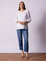 Blusa de broderie color blanco, de mangas largas con puños elásticos.