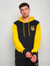 Hoodie negro con mangas amarillas y escudo bordado en el pecho.