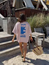 Remerón rosa de algodón con estampado azul en la espalda que incluye una mano haciendo el gesto de 'OK' y la frase 'It's all good'.