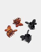 Set de cuatro mini broches para el pelo en forma de mariposa, dos en color carey y dos en color negro.
