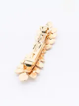 Broche para el pelo dorado con forma de hojas.