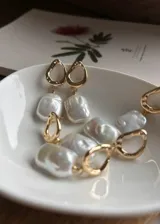 Caravanas con perlas barrocas de río, hechas en plata 925 con baño de oro y broche mariposa.