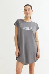 Vestido corto color verde oliva con estampado de dos rostros en color blanco.