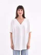 Blusa blanca de mangas cortas con escote en V.