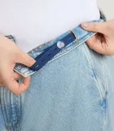 Pantalón de jean wide leg color celeste claro, con bolsillos embutidos y recortes marcados. Presenta bolsillos traseros tradicionales y ruedo sencillo.