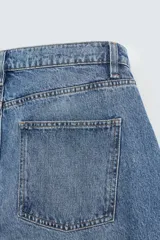 Pantalón de jean negro de corte amplio, estilo balloon fit, con cinco bolsillos y cierre frontal con botones.