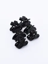 Set de seis pinzas para el pelo de color negro con diferentes diseños.