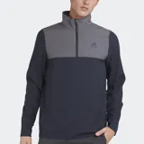 Buzo deportivo Le Coq Sportif de manga larga, con cuello alto y cierre parcial frontal. Presenta un diseño de bloques de color: la parte superior del pecho y el cuello son de color gris, mientras que el resto del cuerpo y las mangas son de color azul marino. Lleva el logo de la marca bordado en el pecho.