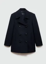 Abrigo de doble botonadura color negro, con corte oversized y diseño amplio.