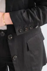 Blazer negro de corte clásico con solapas y cierre con botones.
