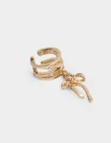 Aro cuff dorado con dije de moño con strass rosa.