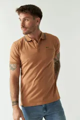 Remera polo negra de manga corta con cuello clásico, cierre de botones, bolsillo en el pecho y logo estampado.