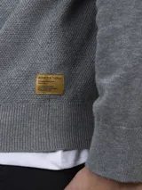 Sweater gris de algodón con cuello redondo.