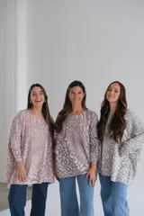Sweater oversized de cuello redondo y manga larga caída, con estampado abstracto animal print en tonos grises y rosados.
