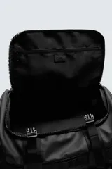 Mochila negra fabricada en tejido técnico. Tiene un compartimento principal con cierre mediante hebillas de liberación rápida y cremallera, un bolsillo interior con cierre, parte posterior acolchada con banda de sujeción para equipaje, dos asas de mano y dos asas de hombro ajustables.