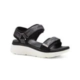Sandalias bajas color beige con plataforma blanca y tiras con ajuste de velcro.