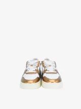 Zapatillas urbanas Autry Medalist Low, de cuero color blanco con detalles en dorado metalizado. Presentan puntera perforada, cierre con cordones, logo de la marca en el lateral y suela de goma color crema.