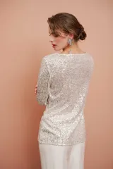 Top color champagne con lentejuelas y cuello drapeado.