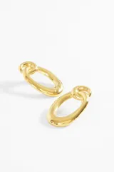 Par de caravanas de acero plateado con forma orgánica, compuestas por un aro superior anudado y un aro inferior ovalado.