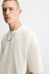 Camiseta negra de corte cuadrado, con cuello redondo, mangas cortas y efecto lavado.