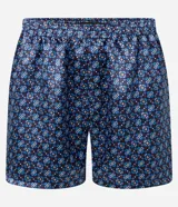 Calzoncillo tipo bóxer de tela de satén estampada con motivos geométricos en tonos azules y marrones. Tiene cintura elástica.
