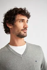 Sweater color beige de tejido de punto con escote en V, fit regular, manga larga y logo bordado en el pecho.