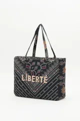 Bolso tipo tote bag negro con estampado geométrico multicolor y la palabra 'Liberté' bordada en dorado.