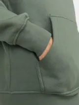 Canguro verde con capucha y cordones ajustables, bolsillo tipo canguro y puños y bajo acanalados. Estampado en relieve con el texto "Originals Studio BROUGHT TO YOU BY JACK&JONES® DESIGNED IN COPENHAGEN".