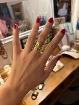 Anillo dorado ancho con textura martillada, hecho artesanalmente en bronce y regulable.