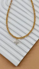 Gargantilla de cristalitos facetados color amarillo con dije de punto de luz blanco.