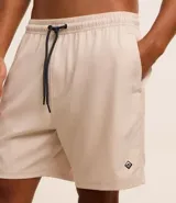 Bermuda color beige con cintura elástica ajustable con cordón negro, bolsillos laterales y logo bordado en la parte inferior de la pierna derecha.
