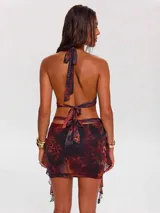 Vestido corto con estampado animal print en tonos marrones, con escote halter y abertura en la cintura.