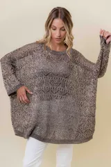 Buzo tejido liviano color bronce/marrón con diseño calado y textura sutilmente brillante. Presenta un calce amplio y mangas amplias, con detalle de tiras entrecruzadas en la espalda.