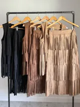 Chaleco de gamuza color marrón con flecos largos y caídos.