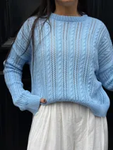 Sweater tejido de punto color rosa con diseño de ochos.