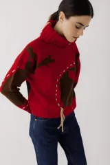 Sweater de punto color verde militar con cuello alto y bordados de hilo color mostaza.