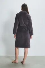 Bata larga de poliéster color gris oscuro con textura acolchada en forma de rombos, cuello tipo chal, bolsillos laterales y cinturón.