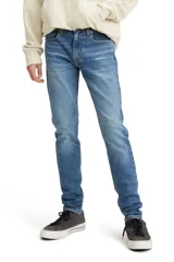 Jean skinny de tiro medio en tono azul, con ajuste entallado y diseño moderno.