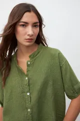 Camisa verde oliva de lino con cuello mao, mangas cortas abullonadas y cierre frontal con botones.