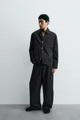 Zueco de cuero color negro con acabado serraje, plantilla acolchada, horma redonda y suela con volumen.