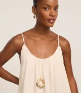 Vestido midi de color negro confeccionado en tejido de viscolino. Cuenta con breteles finos, escote redondo con pliegues frontales y un panel con volado en el ruedo.