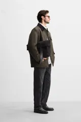 Parka relaxed fit color verde oscuro confeccionada en tejido de algodón con acabado encerado. Tiene cuello solapa combinado en pana negra, manga larga acabada en puño ajustable con botón a presión, bolsillos frontales de plastrón con solapa, bolsillo interior y cierre frontal de botonadura oculta por solapa.