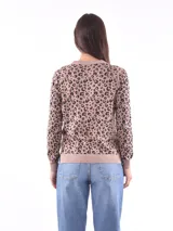 Cárdigan color beige con estampado animal print marrón, escote en V y cierre frontal con botones.