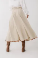 Falda midi color beige de tejido de punto acanalado, corte evasé y cintura alta.
