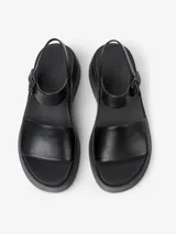 Sandalias negras de cuero vacuno con plataforma y hebilla ajustable en el tobillo.