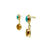 Aretes colgantes largos hechos artesanalmente en bronce. Cada arete presenta dos piedras naturales engarzadas: una superior ovalada de color turquesa y una inferior ovalada de color marrón dorado (posiblemente ojo de tigre).